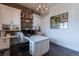 Home office featuring custom built-ins, a large desk, hardwood flooring and a modern light fixture at 5767 Pelican Shores Dr, Longmont, CO 80504