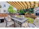 Spacious back deck with comfortable seating and partial awning offers a delightful view of the fenced yard and lush surroundings at 7840 S Windermere Cir, Littleton, CO 80120