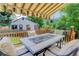 Charming outdoor deck with shaded awning and comfortable seating, perfect for enjoying the well-manicured backyard at 7840 S Windermere Cir, Littleton, CO 80120