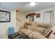 Finished basement Gathering room with cozy decor and comfortable seating area at 7840 S Windermere Cir, Littleton, CO 80120