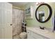 Bright bathroom featuring a vanity with a round mirror and coordinated fixtures at 7840 S Windermere Cir, Littleton, CO 80120