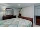 Spacious bedroom features a cozy bed, a closet, and dark wood furniture at 7840 S Windermere Cir, Littleton, CO 80120