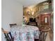 Inviting dining area adjacent to the staircase showcases warm lighting and a floral tablecloth at 7840 S Windermere Cir, Littleton, CO 80120