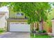 Charming two-story home featuring a two-car garage, mature tree, and well-maintained lawn at 7840 S Windermere Cir, Littleton, CO 80120