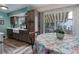 Eat-in kitchen featuring stylish cabinets, stainless appliances, and lots of natural light at 7840 S Windermere Cir, Littleton, CO 80120
