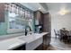 Modern kitchen featuring a large farmhouse sink and sleek countertops at 7840 S Windermere Cir, Littleton, CO 80120