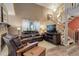 Cozy living room with a stone fireplace, and staircase at 7840 S Windermere Cir, Littleton, CO 80120