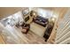 Bright living room showcasing a stone fireplace, wood floors, and comfortable seating at 7840 S Windermere Cir, Littleton, CO 80120