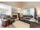 Comfortable living room with stone fireplace, vaulted ceiling, and abundant natural light at 7840 S Windermere Cir, Littleton, CO 80120