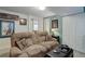 Comfortable living room showcasing a plush sofa with themed pillows and neutral decor at 7840 S Windermere Cir, Littleton, CO 80120
