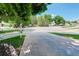 Wide driveway leads to a quiet residential street with mature trees and well-kept homes at 7840 S Windermere Cir, Littleton, CO 80120