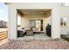 Covered back patio with an outdoor kitchen, fire pit, and comfortable seating at 11052 Sedalia St, Commerce City, CO 80022