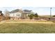 Back yard features a well-maintained lawn, fence, and outdoor dining set with lots of privacy at 11052 Sedalia St, Commerce City, CO 80022