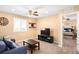 Cozy bedroom featuring soft lighting, a ceiling fan, and a comfortable seating area at 11052 Sedalia St, Commerce City, CO 80022