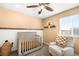 Neutral Bedroom showcases a cozy chair, decorative touches, and a charming gray baby crib at 11052 Sedalia St, Commerce City, CO 80022