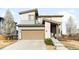 Attractive two-story home featuring a two-car garage, a well-maintained lawn, and a welcoming entrance at 11052 Sedalia St, Commerce City, CO 80022