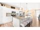 Bright and spacious kitchen with a center island, granite countertops, stainless steel appliances, and modern cabinetry at 11052 Sedalia St, Commerce City, CO 80022