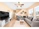 Comfortable living room with a large sectional sofa, modern decor, and abundant natural light at 11052 Sedalia St, Commerce City, CO 80022