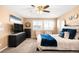 This is a main bedroom with neutral paint, plush carpet, and windows with bright natural light at 11052 Sedalia St, Commerce City, CO 80022
