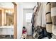 Walk-in closet with hanging clothes, shoes and shelf storage adjacent to the main bathroom at 11052 Sedalia St, Commerce City, CO 80022