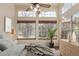 Bright bedroom with large windows, wood blinds, ceiling fan, and decorative accents at 13792 E Lehigh Ave # E, Aurora, CO 80014