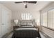 Staged bedroom featuring a bed, side tables, lamps and natural lighting at 13792 E Lehigh Ave # E, Aurora, CO 80014