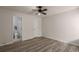 This bedroom has sleek floors, neutral walls, ceiling fan, and an adjoining bathroom at 13792 E Lehigh Ave # E, Aurora, CO 80014