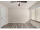 This bedroom has sleek floors, neutral walls, a ceiling fan, and natural lighting at 13792 E Lehigh Ave # E, Aurora, CO 80014