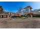 Charming building with manicured landscaping, brick accents, and architectural interest under a clear blue sky at 13792 E Lehigh Ave # E, Aurora, CO 80014