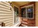 Close up of home entrance with brick detail, security door, and decorative wreath at 13792 E Lehigh Ave # E, Aurora, CO 80014