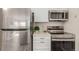 Modern kitchen features stainless steel appliances including a refrigerator, oven, and microwave at 13792 E Lehigh Ave # E, Aurora, CO 80014
