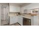 White kitchen with stainless steel appliances and view to another room at 13792 E Lehigh Ave # E, Aurora, CO 80014