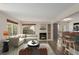 Cozy living room with a fireplace, comfortable seating, and natural light at 13792 E Lehigh Ave # E, Aurora, CO 80014