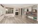 Living room with a fireplace, kitchen access, and modern flooring at 13792 E Lehigh Ave # E, Aurora, CO 80014