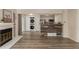 Living space with a fireplace, laundry, and kitchen area at 13792 E Lehigh Ave # E, Aurora, CO 80014