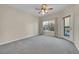 Spacious bedroom with ceiling fan and access to a private balcony at 1050 Opal St # 102, Broomfield, CO 80020
