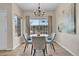 Bright dining area with a wooden table and four gray chairs at 1050 Opal St # 102, Broomfield, CO 80020