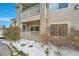 Side view of the building with snowy landscaping at 1050 Opal St # 102, Broomfield, CO 80020
