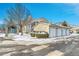 Attached garages with driveway and snow covered landscaping at 1050 Opal St # 102, Broomfield, CO 80020