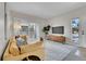 Bright living room with a cozy yellow sofa, modern decor, and sliding glass doors to the outside at 1050 Opal St # 102, Broomfield, CO 80020