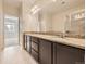 Bathroom with dual vanity sinks, granite countertops, and a large mirror at 600 E Dry Creek Pl, Littleton, CO 80122