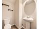 Bathroom featuring a pedestal sink, decorative wall shelves, and modern fixtures at 600 E Dry Creek Pl, Littleton, CO 80122