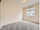 Cozy bedroom featuring neutral walls, plush carpet, and a window that brings in sunlight at 600 E Dry Creek Pl, Littleton, CO 80122