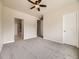 Spacious bedroom featuring neutral carpet and ceiling fan with access to ensuite bath at 600 E Dry Creek Pl, Littleton, CO 80122