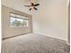 Comfortable bedroom with plush carpet, large window, and ceiling fan at 600 E Dry Creek Pl, Littleton, CO 80122