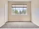 Bedroom features a large window and neutral walls at 600 E Dry Creek Pl, Littleton, CO 80122