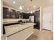 Modern kitchen featuring dark cabinets, granite countertops, and stainless steel appliances at 600 E Dry Creek Pl, Littleton, CO 80122