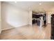 Open-concept living space with wood floors flowing into a modern kitchen at 600 E Dry Creek Pl, Littleton, CO 80122