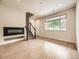 Inviting living room with hardwood floors, fireplace, and staircase with carpeted steps at 600 E Dry Creek Pl, Littleton, CO 80122