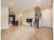 Inviting living room featuring wood floors, fireplace, staircase, and an open view of the kitchen at 600 E Dry Creek Pl, Littleton, CO 80122
